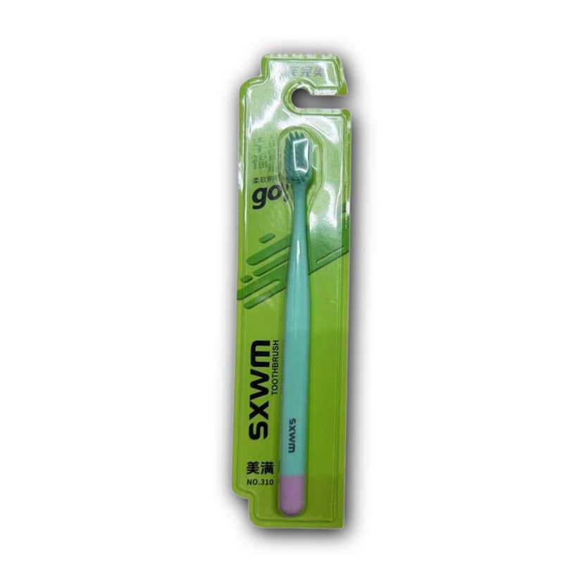 Toothbrush 310 in packaging with soft bristles
