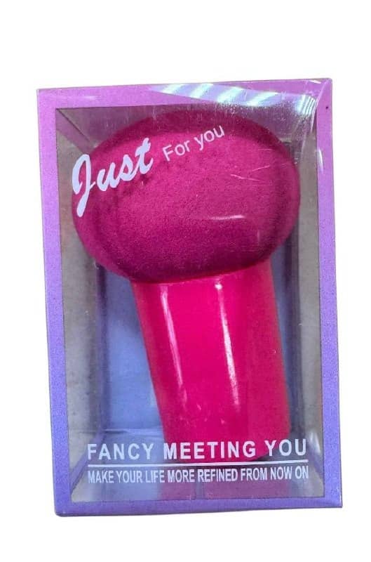 Plastic sponge with handle in raspberry color in plastic box — compact helper for washing dishes