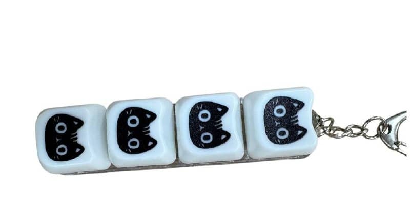 Kitty 4-key clicker keychain with white square keys featuring black kitten faces with large round