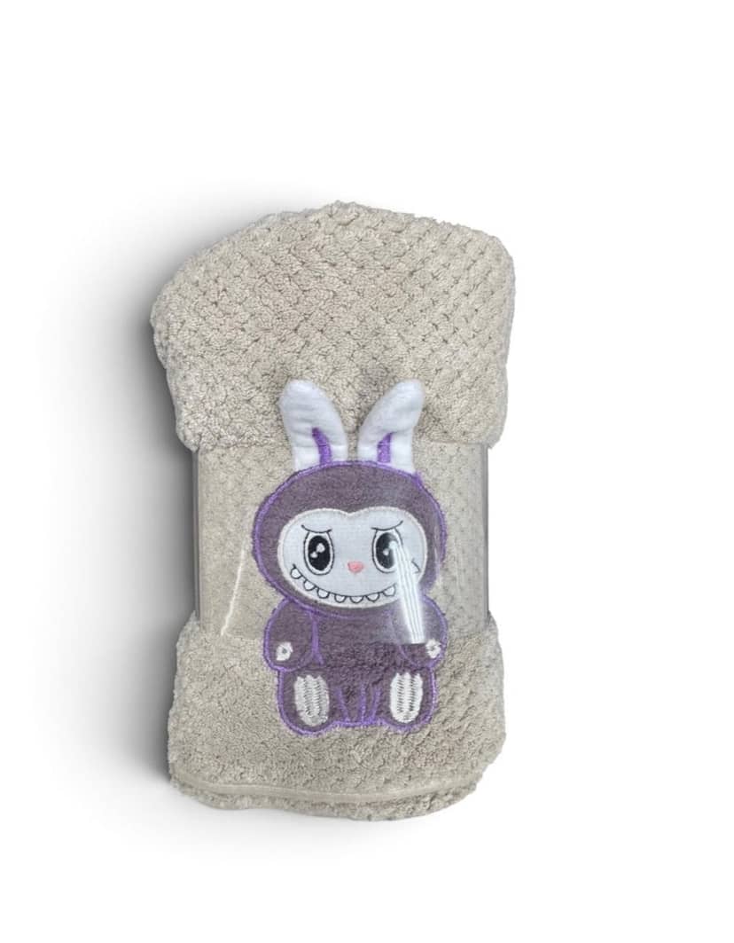 Beige towel with purple cartoon rabbit design